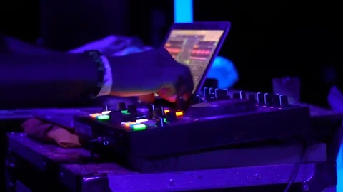 Close up of DJ twisting the knobs on his equipment at the party Stock Footage 118357167