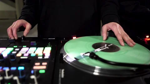 Close up of DJ at work, mixing, spinning and scratching on a turntable. Art Stock Footage 159818677