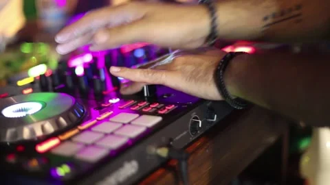 Close-up of DJ working at bar pressing buttons moving sliders at party Stock Footage 194375974