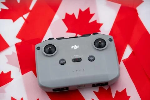 Close up of DJI drone controller on Canadian flag background. Toronto, Canada - Stock Photos