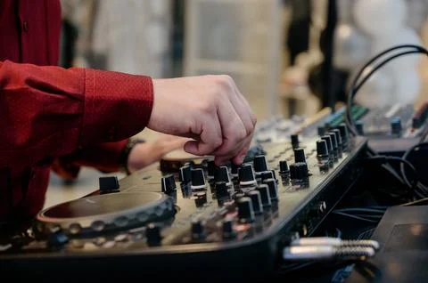 Close-up of a DJs hand on a mixing console Stock Photos