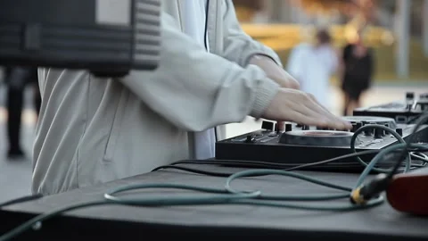 Close-up of DJs hands adjusting knobs and spinning the platter on controller Video stock 317035987