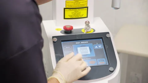 Close-up. Doctor adjusts the laser device for lifting procedure Stock Footage 145012053