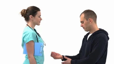 Close-up of doctor checking radial pulse on her male patient wrist. Professional Video stock 121558804