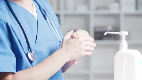 Close-up of doctor cleaning hands using disinfectant with medical soap. Office Stock Footage 140908043