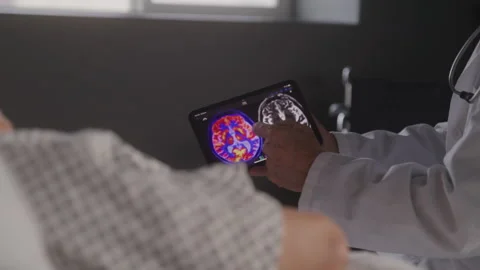 Close up of Doctor Explaining and Mri Brain Scan to a Patient in Hospital Room Stock Footage 208798367