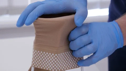 Close up doctor hand prepares compression stockings before surgery. Stock Footage 107384999