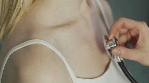 Close-up of doctor hand using stethoscope with a female patient, checking the Video stock 146504433