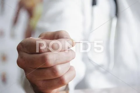 Close Up Of Doctor Holding Needle