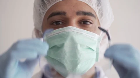 Close Up of Doctor Looking to the Camera Taking Mask Off. Stock Footage 128006477