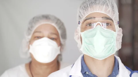 Close Up of Doctor Looking to the Camera Taking Mask Off. Stock Footage 128006492
