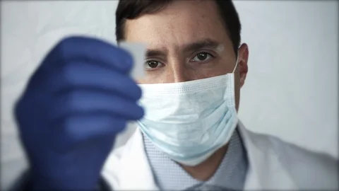 Close-up  doctor looking of the hands in lab technician on a glass plate. sel Stock Footage 94996811
