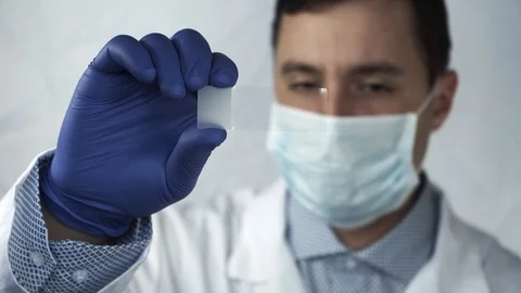 Close-up  doctor looking of the hands in lab technician on a glass plate focu Stock Footage 94996937