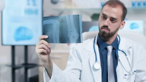 Close up of doctor looking at X Ray scan of a leg Stock Footage 108536167