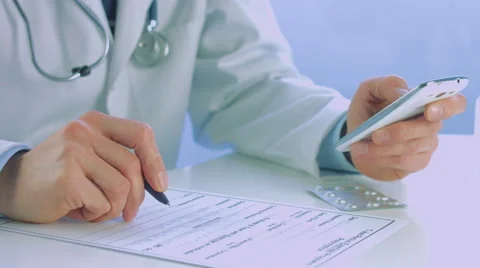 Close up of a doctor male hand using a smart phone Stock Footage 56460787