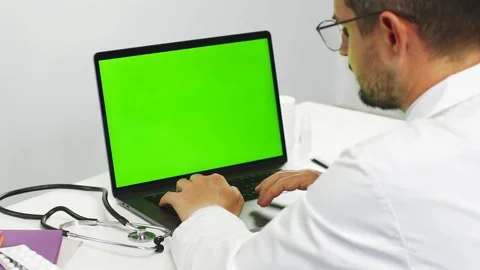 Close-up of doctor scrolling data on chroma key laptop at hospital Stock Footage 135914455