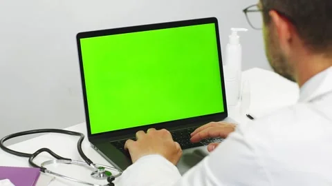 Close-up of doctor using chromakey laptop while work Stock Footage 135914358