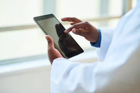 Close-Up of Doctor Using Digital Tablet in Modern Hospital for Patient Care Stock Photos