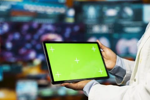 Close up of doctor using green screen mockup tablet app to look at medical data Stock Photos