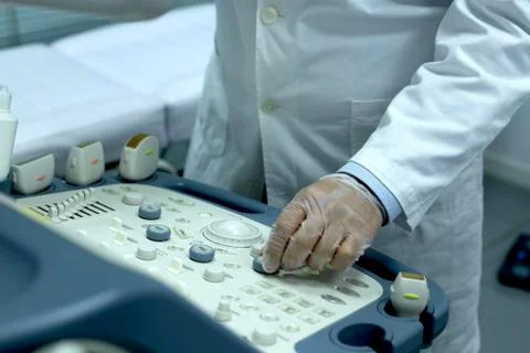 Close-up of a doctor using a machine to perform an ultrasound on a patient Stock Photos