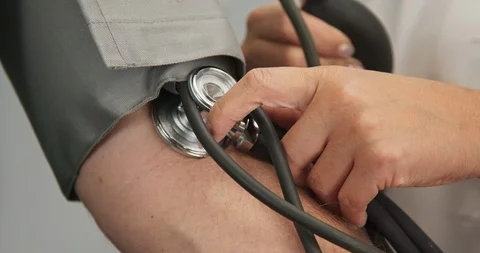 Close up on doctor using sphygmomanometer to check patient blood pressure Video stock 101401215