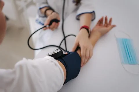 Close-up of doctor using sphygmomanometer with stethoscope checking blood Foto stock