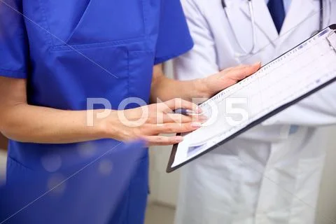 Close up of doctors with clipboard at hospital Stock Photos