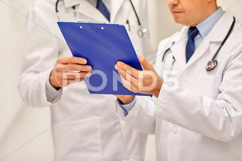 Close up of doctors with clipboard at hospital Stock Photos