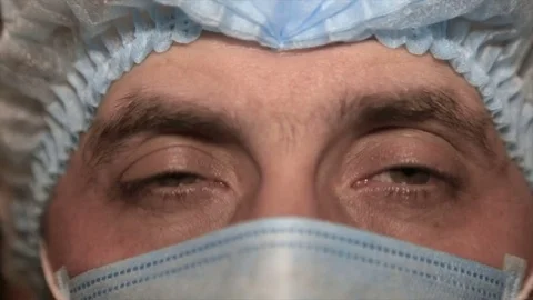 Close-up of a doctor's face in a medical mask, after surgery Stock Footage 73441553