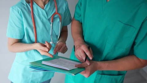 Close-up of doctors hand discussing patient treatment plan. Man and woman in Video stock 118086189