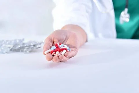 Close-up of a doctor's hand holding assorted medicines Stock Photos
