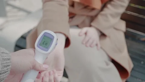 Close-up. Doctor's hand holding non-contact digital infrared thermometer for Stock Footage 154040185