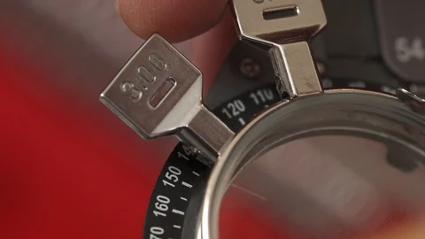 Close-up of doctors hand loading a necessary lens into optometrist trial frame Stock Footage 108450812