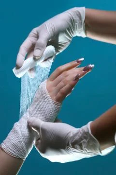 Close-up of a doctor's hand making a bandage for his patient Stock Photos