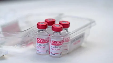 Close-up of doctor's hand pulls out vials with vaccine to treat coronavirus Stock Footage 149519312
