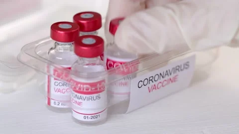 Close-up of doctor's hand pulls out vials with vaccine to treat coronavirus Stock Footage 153489239