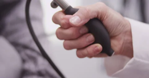 Close-up of doctor's hand pumping pulsometer Video stock 58228034