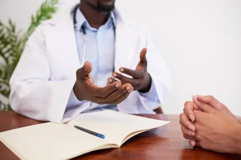 Close up of doctors hands explaining to patient during GP checkup Stock Photos