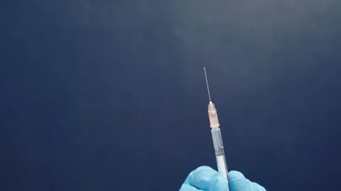 Close-up of a doctor's hands holding medicines comparing them Preparing a Stock-Footage 336586947