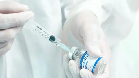 Close-up of a doctor's hands holding medicines comparing them Preparing a Stock-Footage 336587003