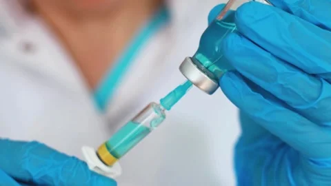 Close-up of a doctor's hands holding medicines comparing them Preparing a Stock-Footage 336587078