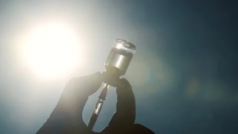 Close up of doctors hands holding a vial to fill a syringe with vaccine Видео 143772633