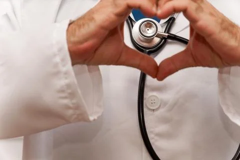 Close-up of a doctor's hands making the heart symbol Stock Photos