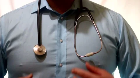 Close-up of a doctor's hands placing a stethoscope on a person's neck. Stock Footage 321370968