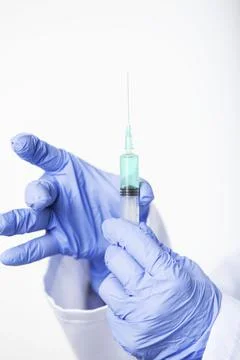 Close up of doctor's hands preparing syringe with new vaccine Stock Photos