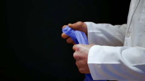 Close up of doctor's hands putting on his nitrile gloves. Stock Footage 127578910