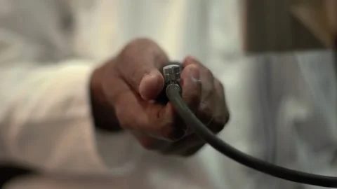 Close-Up of Doctor's Hands Using a Sphygmomanometer Stock Footage 303458503