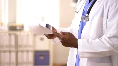 Close up of doctors hands writing out RX prescription and patient are Stock-Footage 336587975