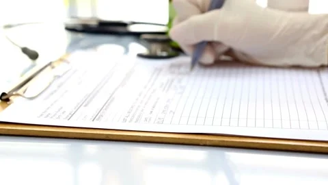 Close up of doctors hands writing out RX prescription and patient are Video stock 336587997