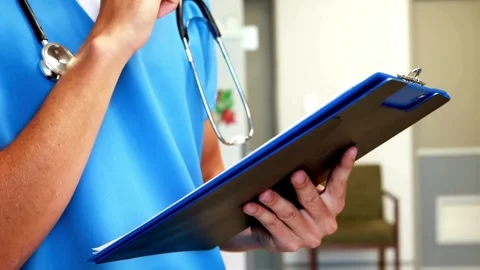 Close up of doctors hands writing out RX prescription and patient are Stock-Footage 336588214